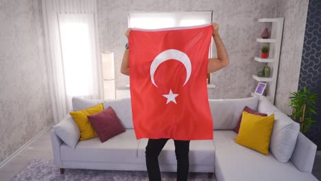 Young-rejoicing-with-Turkish-flag-at-home-in-slow-motion.